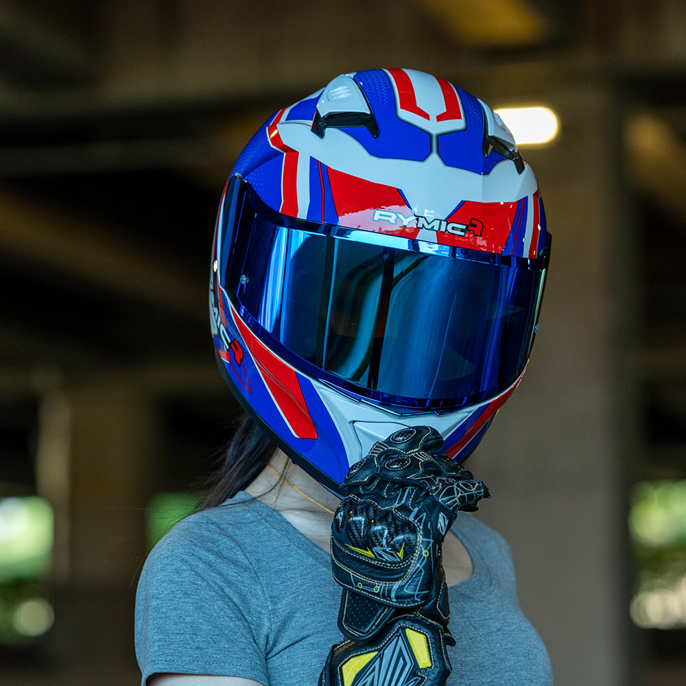 A rider wearing the RYMIC sr6 red & blue full face helmet, showcasing its sleek aerodynamic profile.