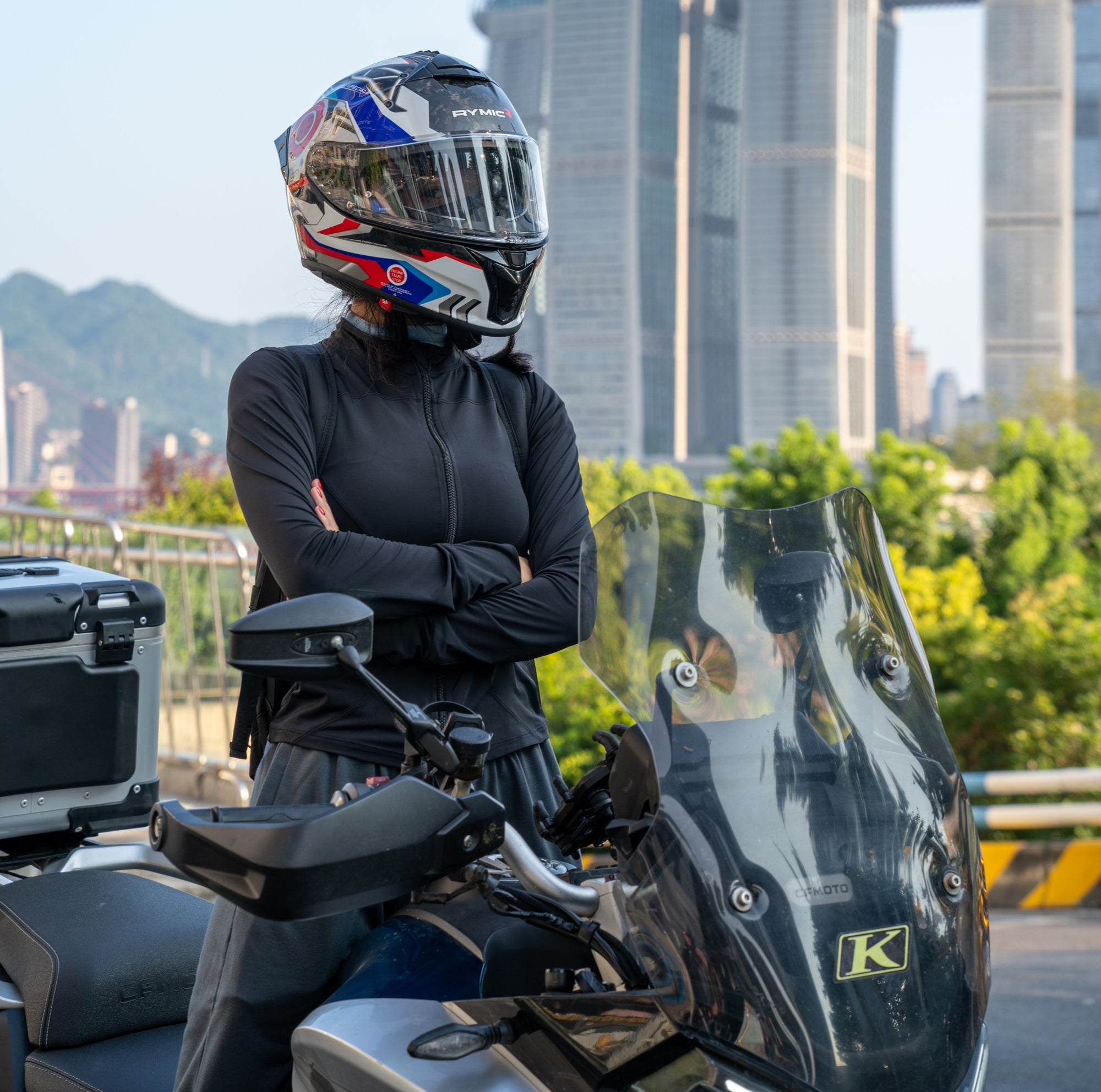 A rider wearing the RYMIC S-GT full face carbon fiber helmet, shown in a side profile.
