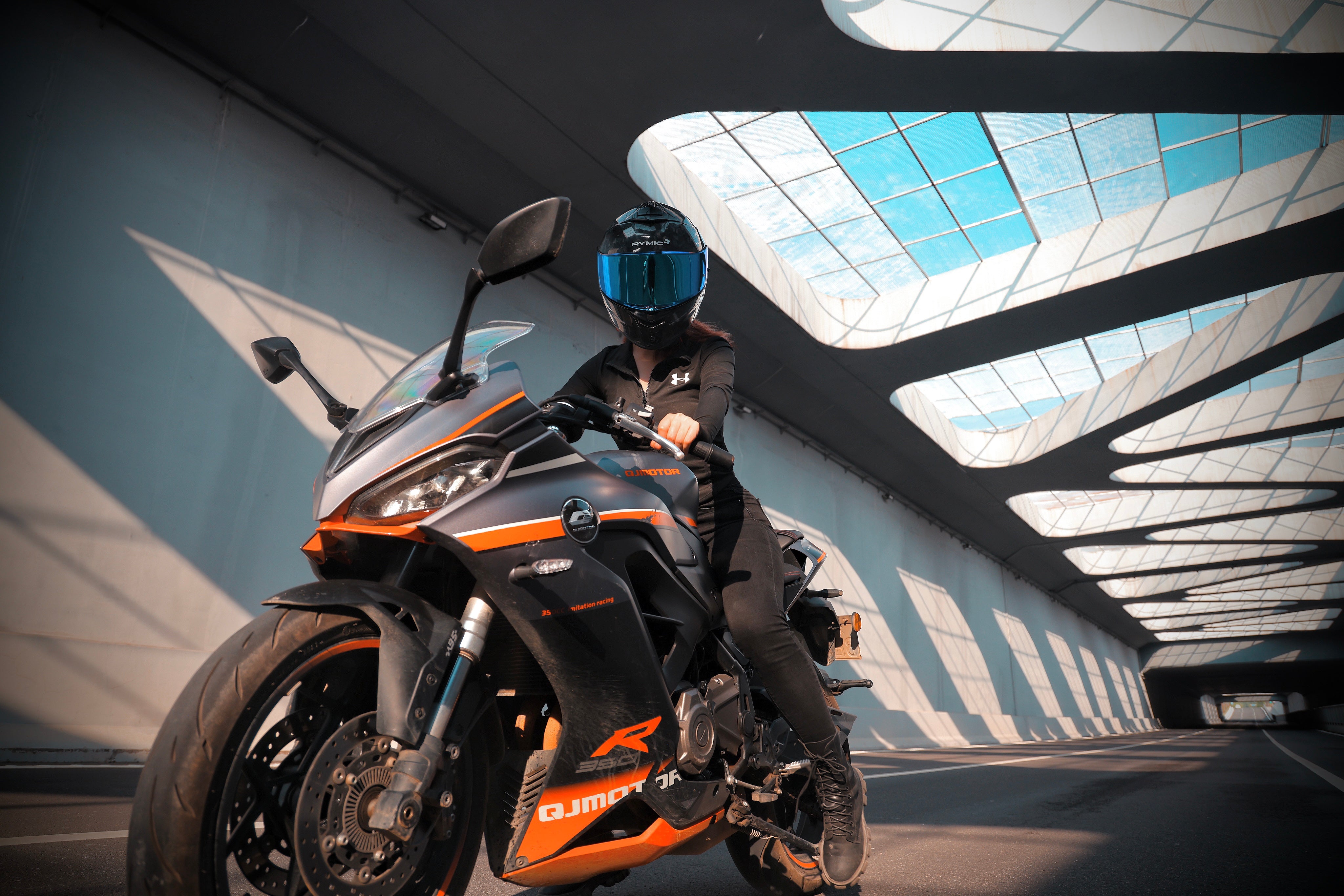 A rider wearing the RYMIC S-GT full face helmet, showcasing its sleek aerodynamic profile.