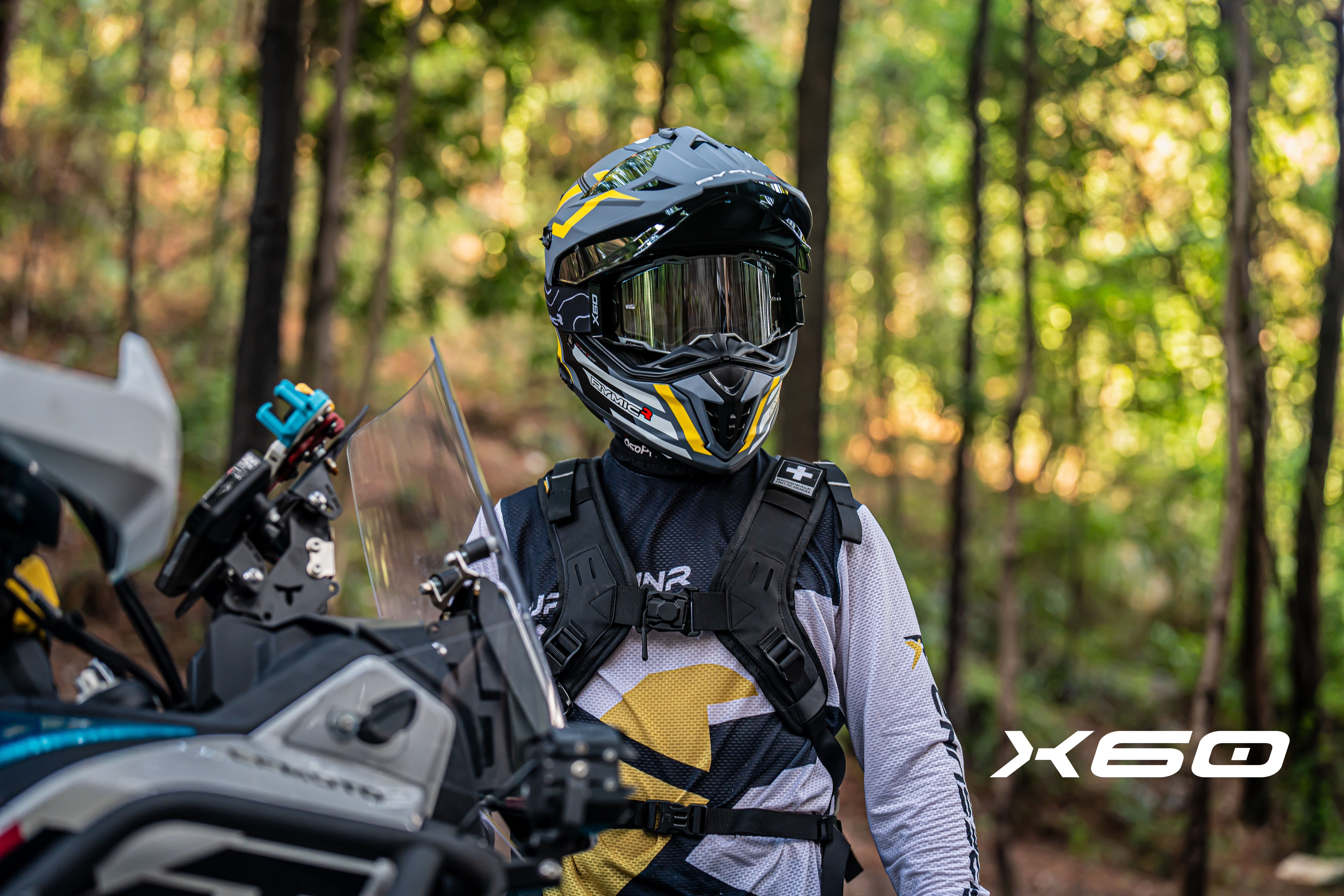 A rider wearing the RYMIC X60 dual sport ADV helmet, showcasing its sleek aerodynamic profile.