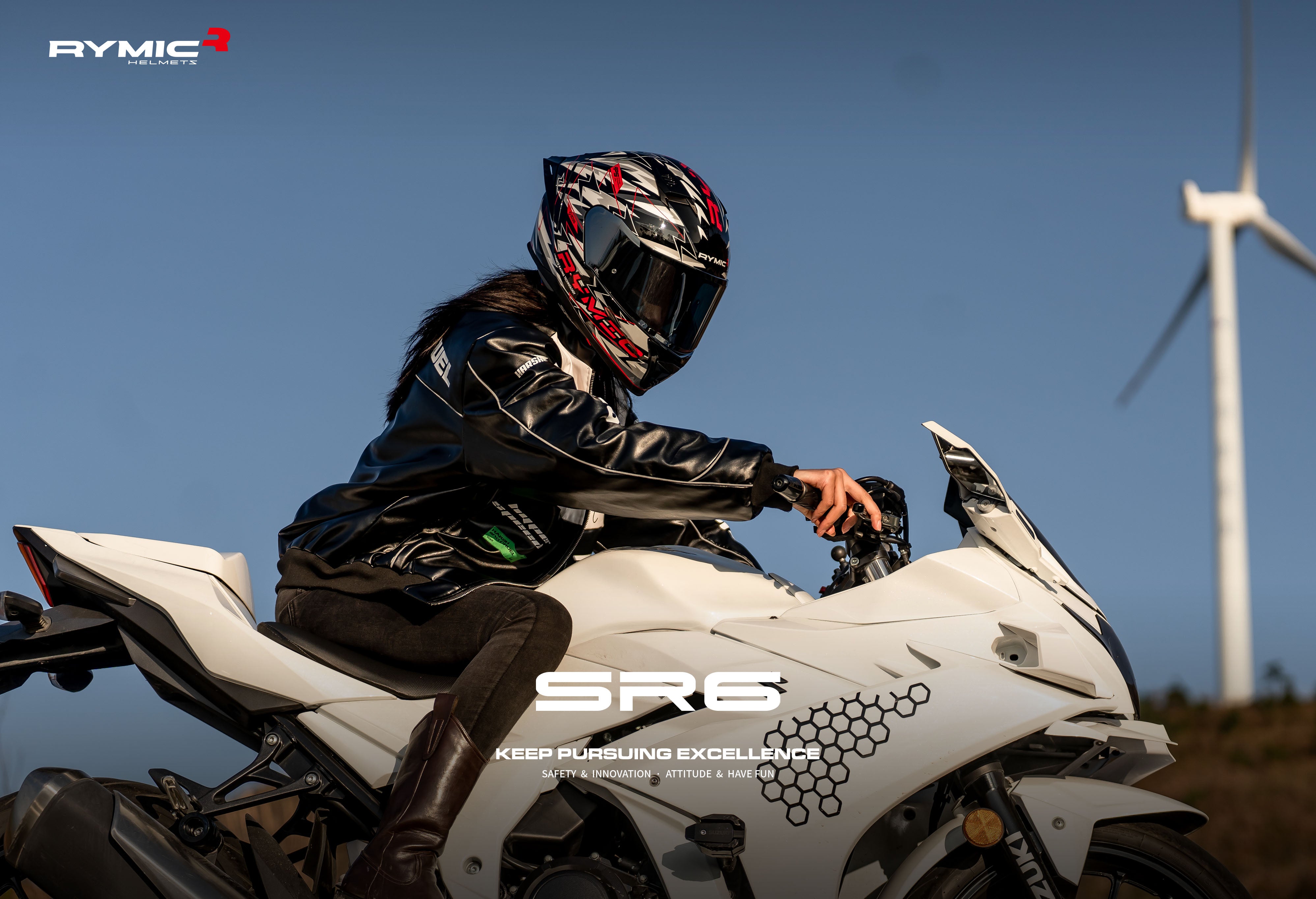 A rider wearing the RYMIC sr6 black & white full face helmet, showcasing its sleek aerodynamic profile.