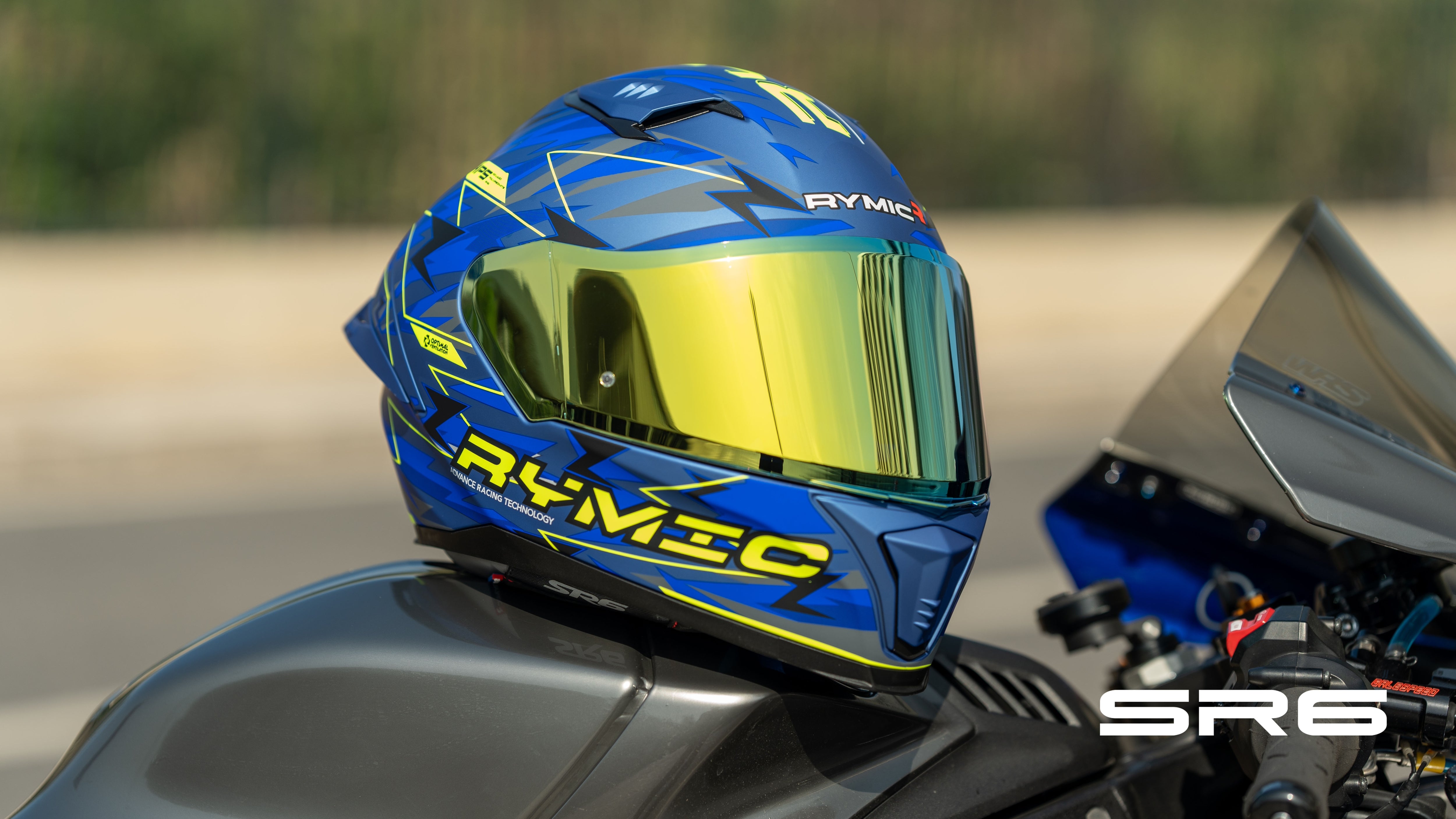 The RYMIC sr6 blue-yellow full face helme is shown on the sport bike.