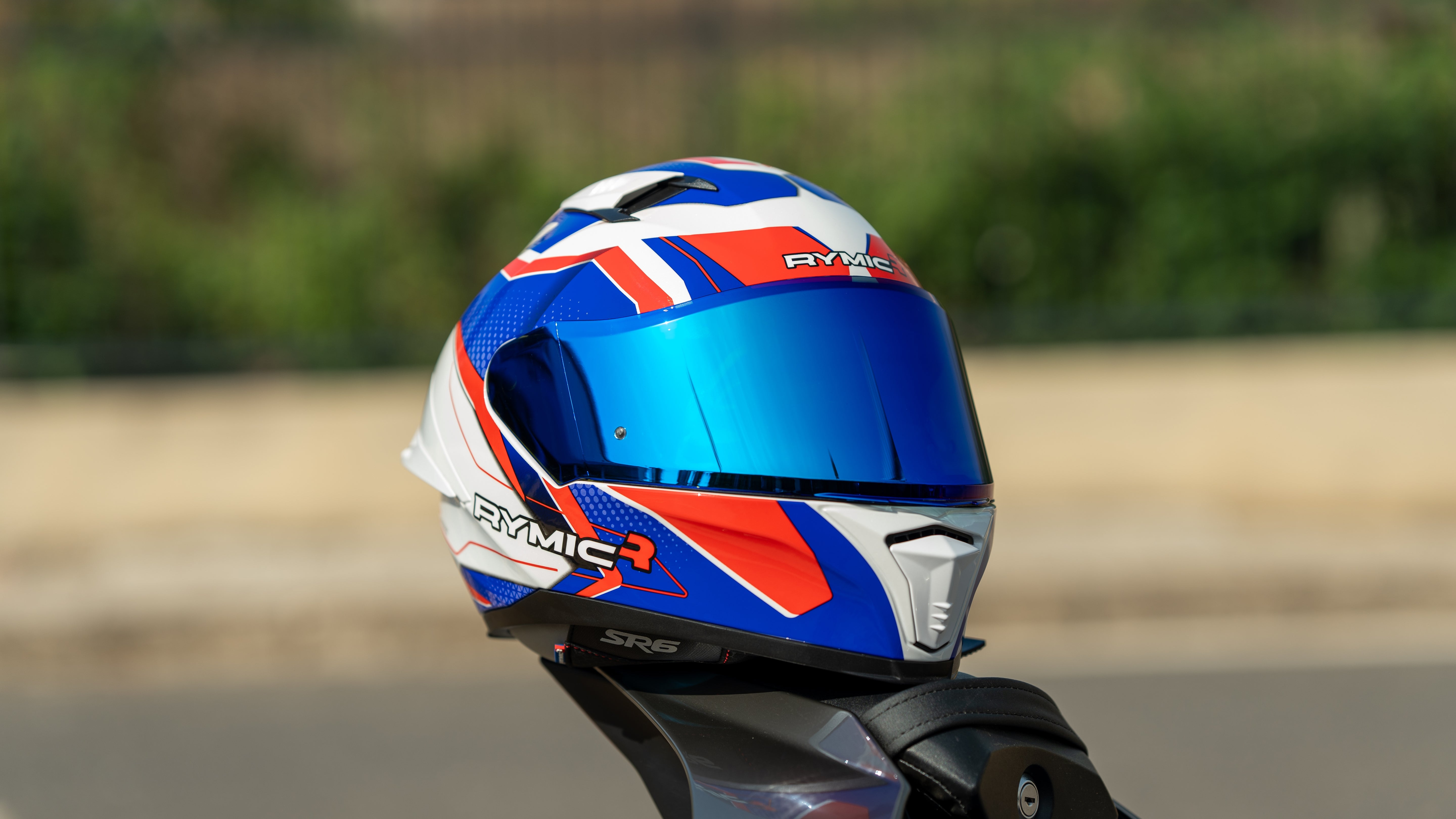 The RYMIC sr6 red & blue full face helme is shown on the sport bike.