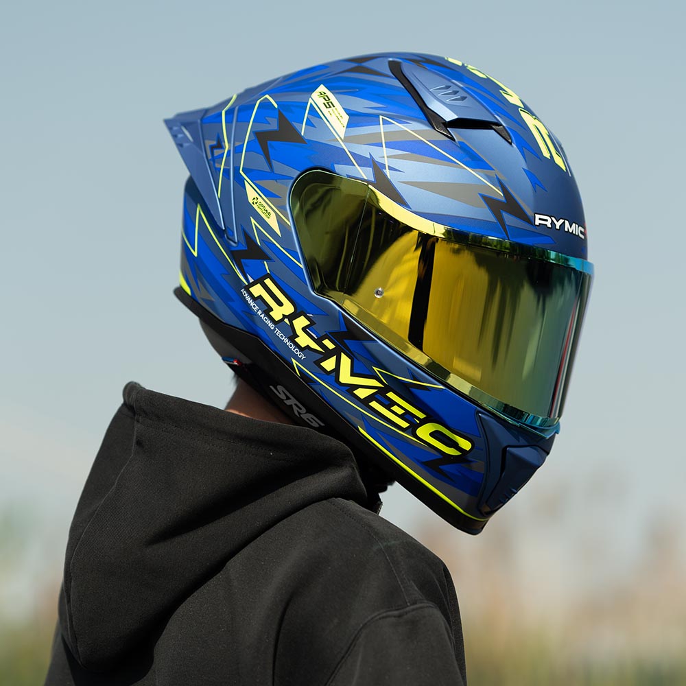 A rider wearing the RYMIC sr6 blue-yellow full face helmet, showcasing its sleek aerodynamic profile.