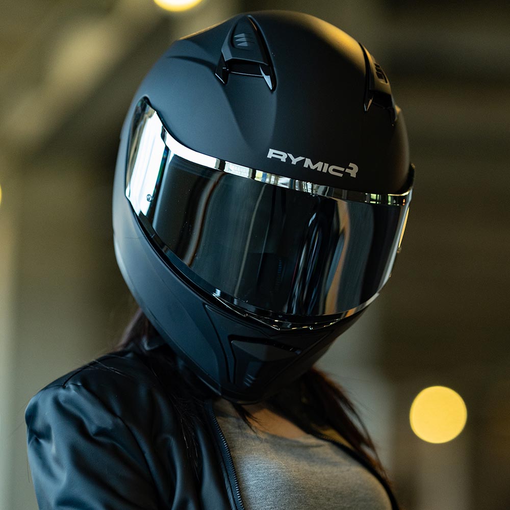 A rider wearing the RYMIC sr6 matte black full face helmet, showcasing its sleek aerodynamic profile.