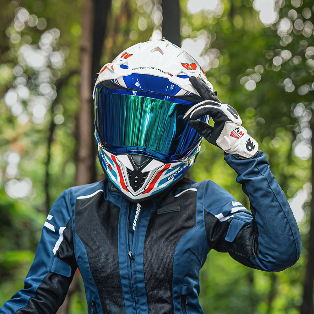An adventurer wearing the X60 dual-sport helmet in vermilion cobalt, ready for touring.